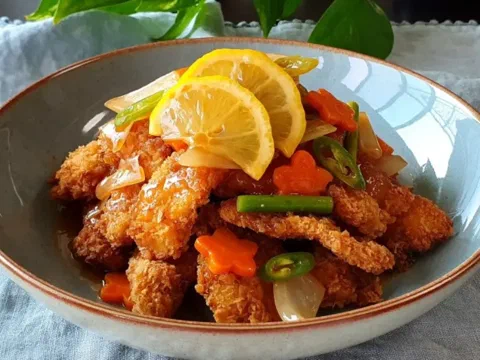 Bocados de pechuga de pollo estilo tangsuyuk, bañados en salsa agridulce con cebolla, champiñones y pimiento